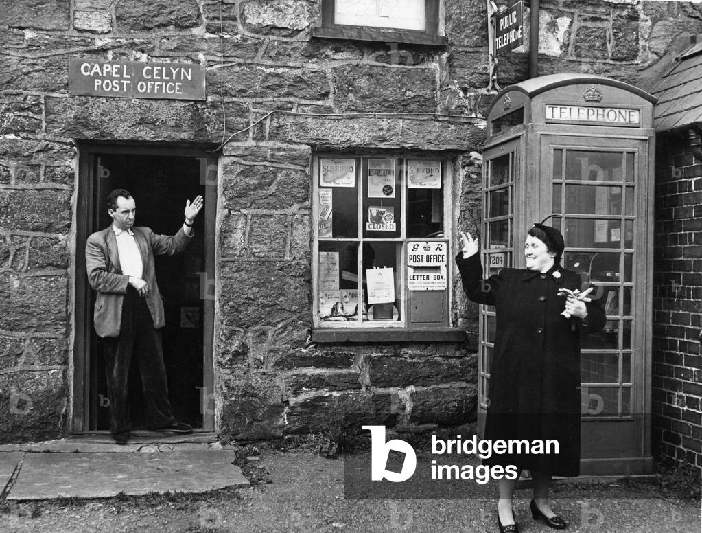 Tryweryn Valley - Mr Jones Parry, the postmaster, outside his post office at Capel Celyn, which will be submerged when the valley is flooded for the reservoir - 10th December 1956 (b/w photo)