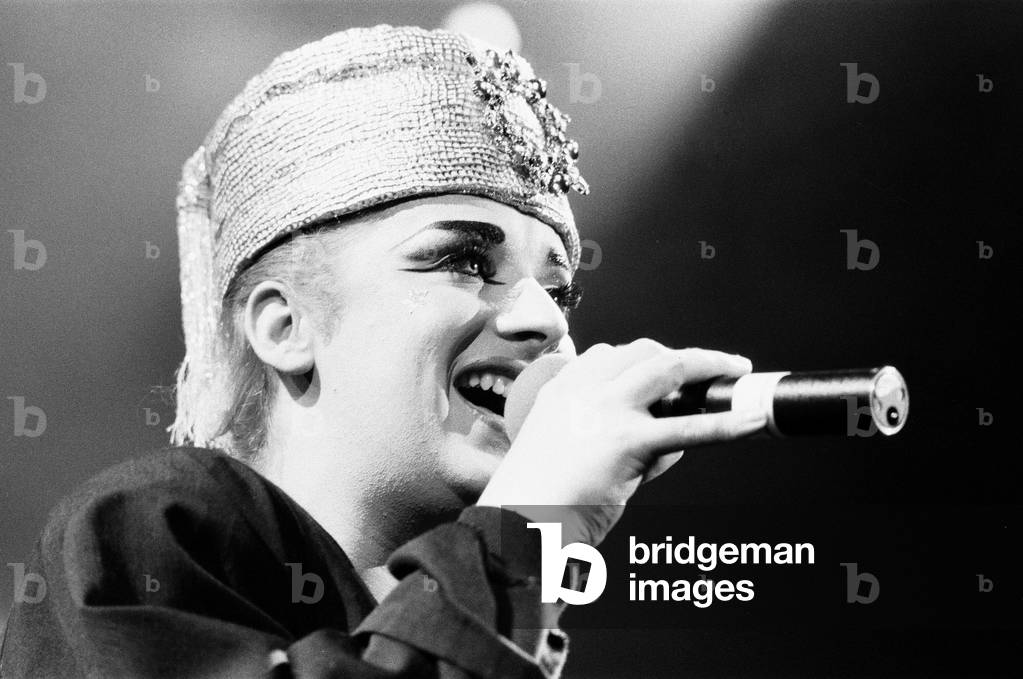 Lead singer with the band Culture Club, Boy George seen here with a 'Boy George' doll back stage at the Rosemont Stadium, Chicago. 11th November 1984