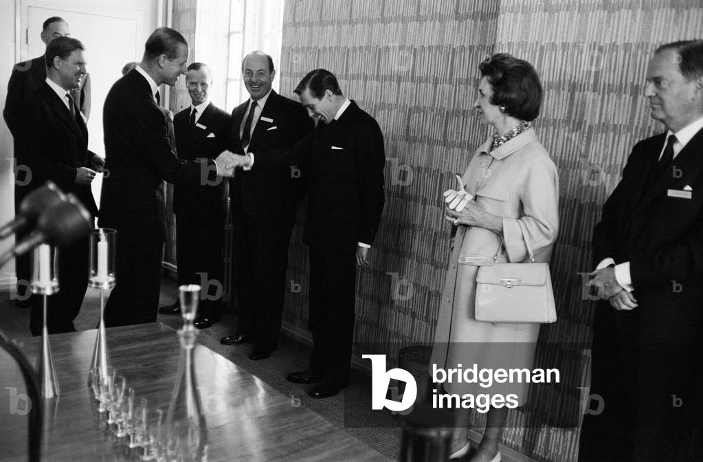 The Duke of Edinburgh at the Design Centre in Haymarket to present Design Centre awards to designers of articles ranging from portable radios to chemical closets. As well as presenting the Design Centre Awards the Duke handed over his own prize of elegant design. Pictured is Lord Snowdon, (Anthony Armstrong-Jones) who could not resist a great grin when he shook hands with his brother-in-law, Prince Philip. Lord Snowdon works for the Council of Industrial Design which runs the Centre. Left to right: Sir Duncan Oppenheim (Chairman of CoID Council), HRH Prince Philip, O H Miller (member of CoID Council and chairman of John Lewis Partnership), Whitney Straight (Deputy Chairman of Rolls Royce, Chairman of Design Centre, Awards Selection Panel 1961) and Lord Snowdon (Mr Antony Armstrong-Jones). London, 17th May 1961 (b/w photo)