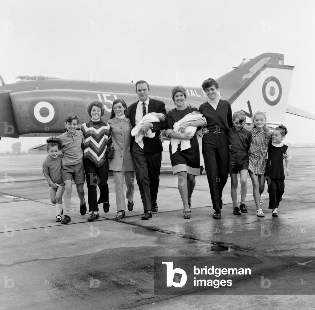 Lieutenant Commander Peter Marshall of HMS Ark Royal and his wife Carolyn, both holding their new born baby twin boys Paul and Mark, pose with their other eight children Kathryn, Ginny, Richard, Melanie, Sally, Carl, Kirstie and Christopher. 24th August 1971 (b/w photo)