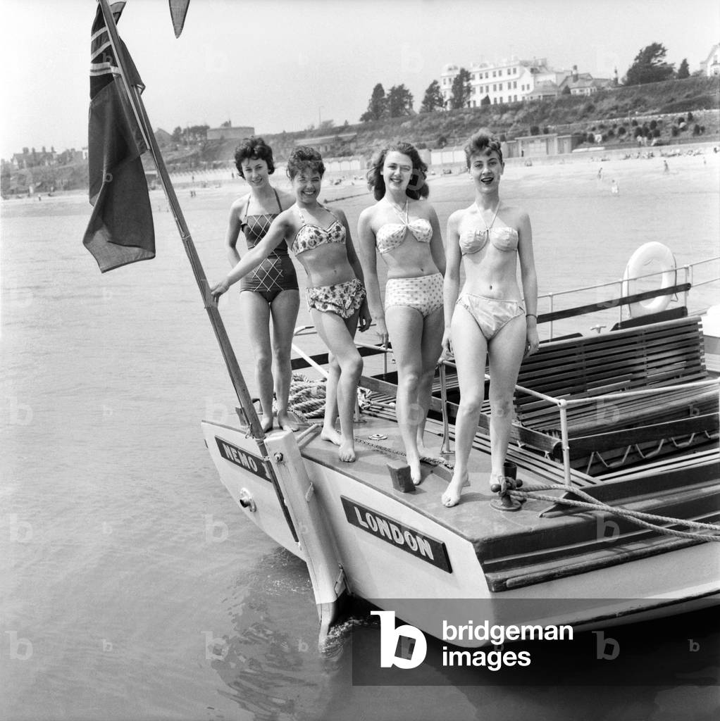 Bathing Girl: Glamour on the Clacton Beach: L. to R. Peggy Palmer, 16, Waitress Clacton; Maureen Kenn, 21, Waitress Clacton; Barbara Jollies, 21, Red Coat Ilford; Sherral Mason, 19, Red Coat Blackpool pushing the boat out. June 1960