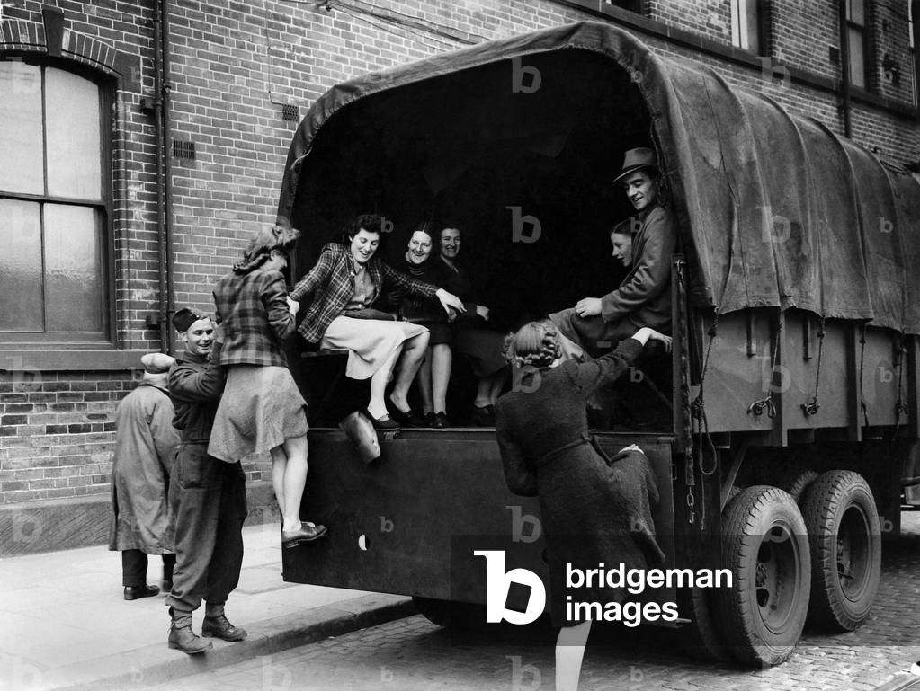 South York tram strikes. Girl munition workers being helped into an army lorry and transported home after their day's work at Rotherham yesterday. May 1943