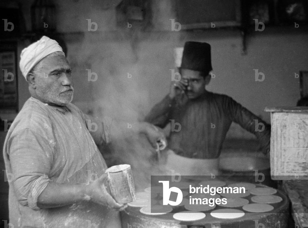 If you can't stand the heat keep out of the kitchen Cooking Katayef a kind of bread in Aleppo in Syria, c. 1935 (b/w photo)