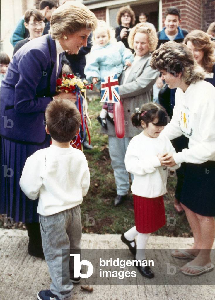 Leanne Venison finds it a little to much to present a posy to Princess Diana during her visit to South Bank. 7th December 1989 (photo)