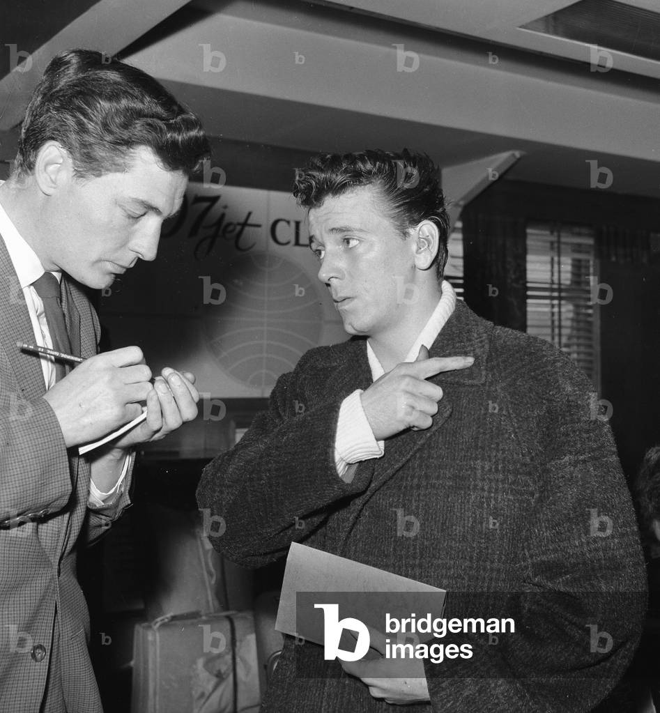 American and roll singer Gene Vincent pictured at London airport as he prepares to fly home to California after he was injured in a car crash that killed fellow rock n roller Eddie Cochran. 27th April 1960 (photo)