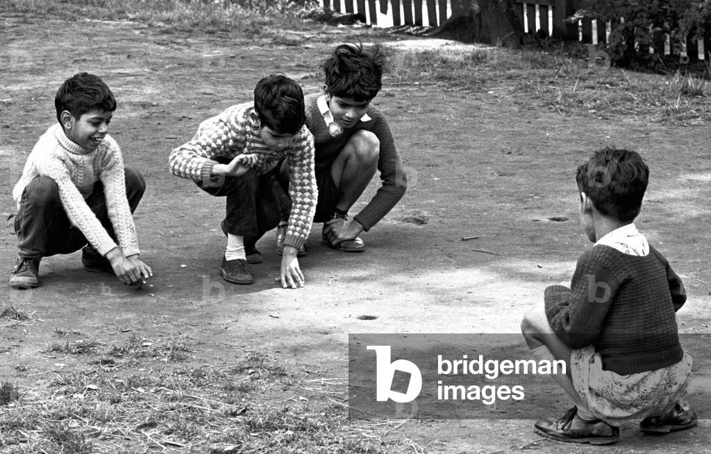Children enjoy a game of marbles in Hillfields, Coventry.
17th August 1962