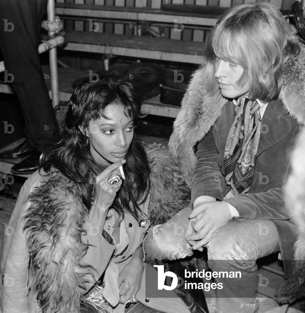 Rolling Stones: Brian Jones at the filming of the Rolling Stones Rock 'n' Roll Circus, which turned out to be his final public appearance with the Stones. He is pictured with model Donyale Luna who played the part of the fire eaters assistant in the Rock 'n' Circus. 11th December 1968 (b/w photo)