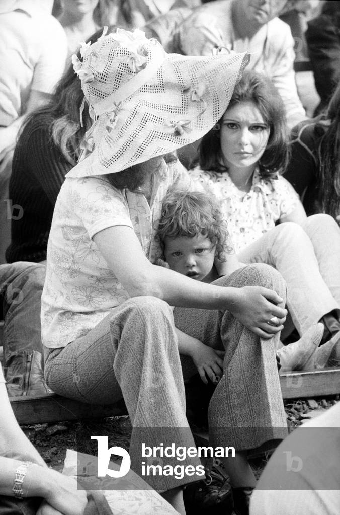 Music fan with young child at The Isle of Wight Festival, 30th August 1970 (b/w photo)