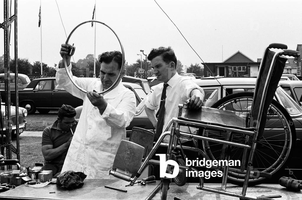 Engineers work on equipment for Paralympic Athletes training at Stoke Mandeville, ahead of the 1964 Paralympics to be held in Tokyo, pictured 22nd July 1964 (b/w photo)