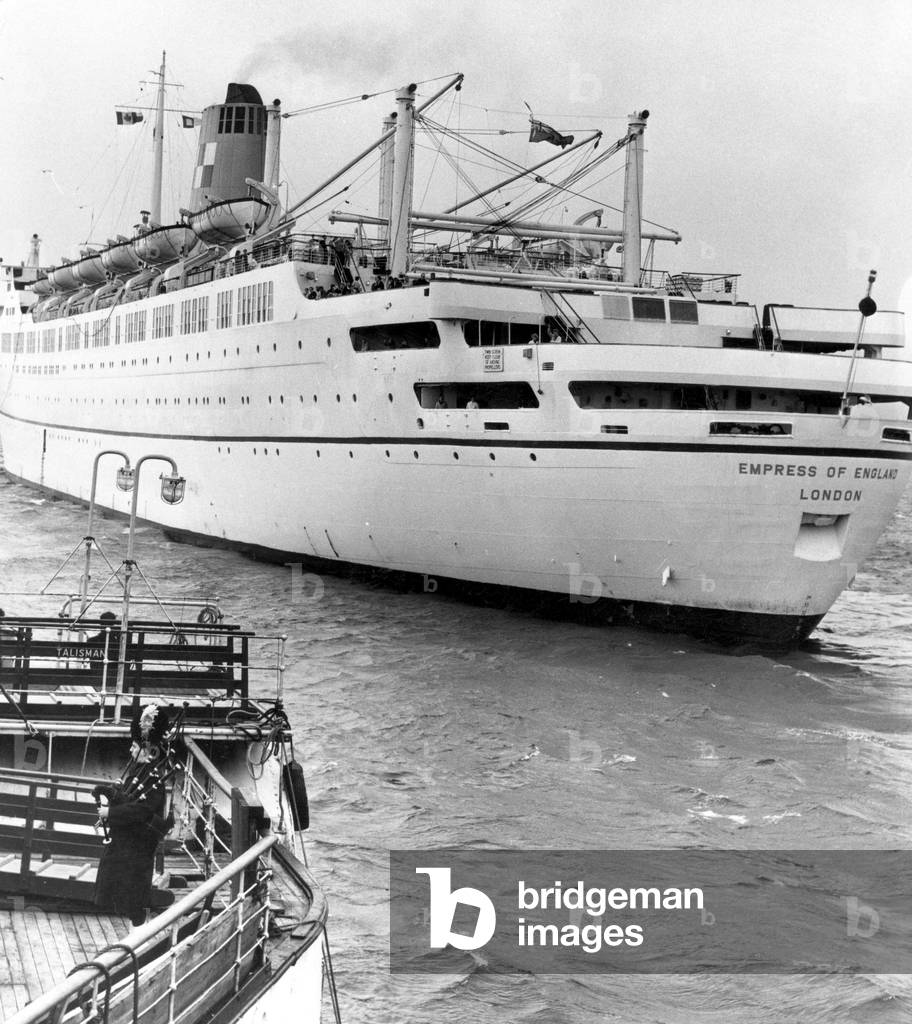 A Scottish piper pipes a send-off for the Canadian Pacific liner Empress of England, on its way to Canada at Greenock after arriving from Liverpool. 9th April 1966 (b/w photo)
