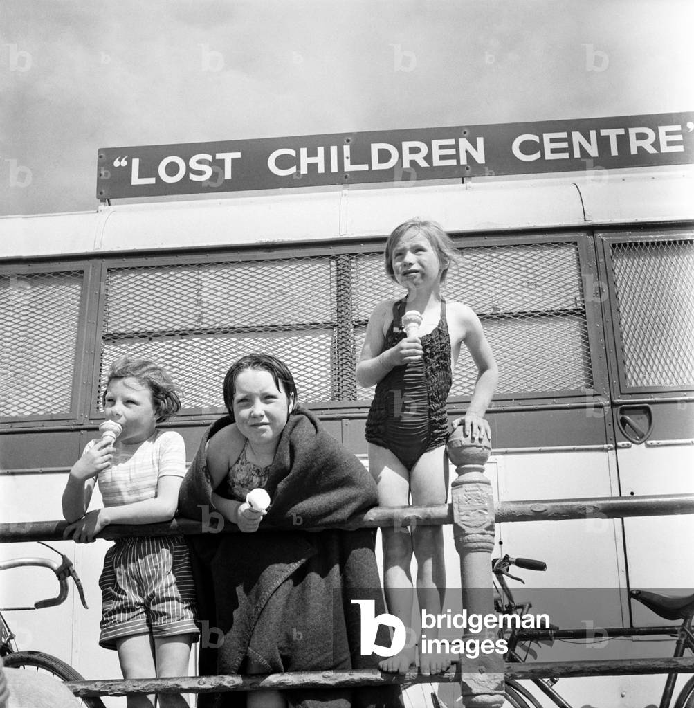 Blackpool beach lost children/sailing/crowds: Lost children at the Missing children caravan on the beach at Blackpool waiting to be claimed by their mums and dads. June 1960