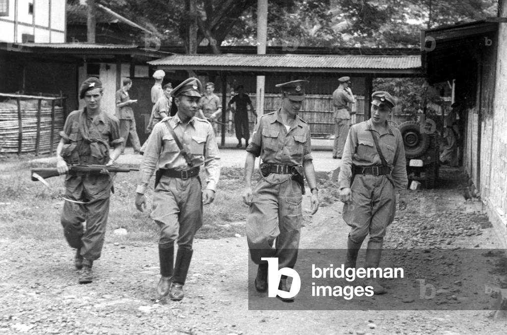 Paratroopers take over Indonesian administration. Two Indonesian policemen are marched away by Paras. of the 5th Airborne Brigade, after being relieved of their Japanese rifles.
 22nd January 1946