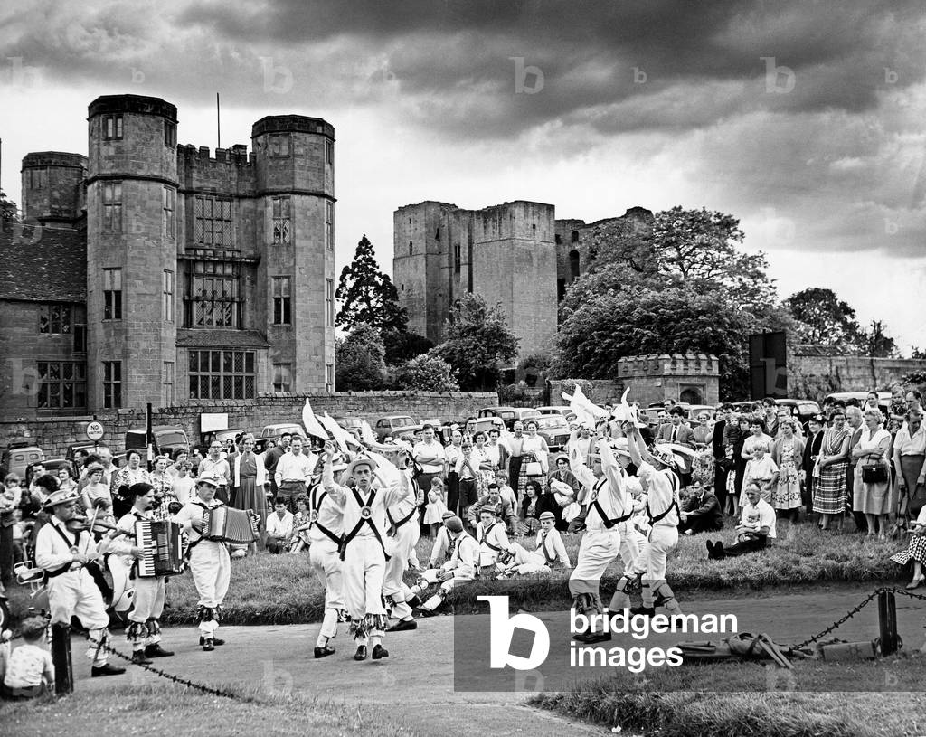 Morris dancers from Coventry giving a display on the green outside Kenilworth Castle. 7th June 1960 (b/w photo)