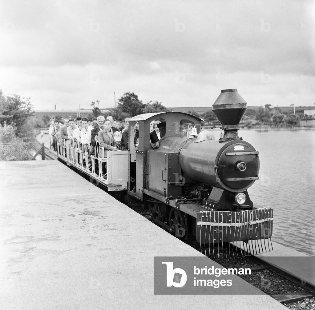 Holidaymakers on a train at Butlins Holiday Camp, Filey, North Yorkshire. 30th July 1954 (b/w photo)