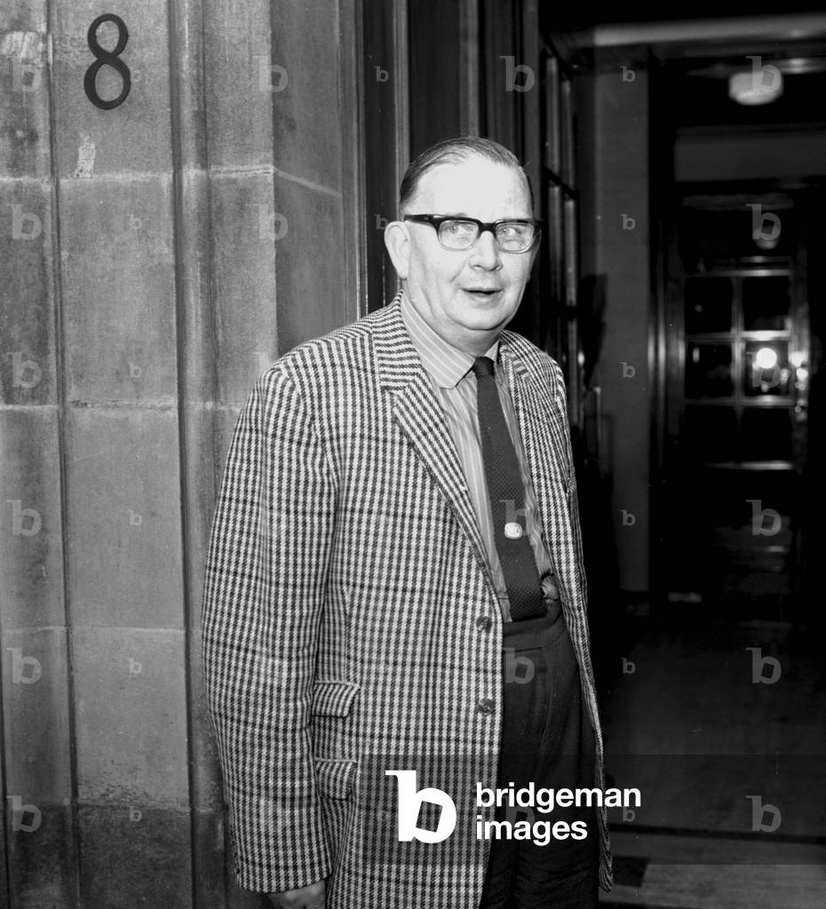 Women sewing machinists at the Ford Motor Company plant in Dagenham took strike action on 7 June, 1968 in support of a claim for regrading, parity with their male colleagues in the C pay grade and recognition of their skills. After 3 weeks on strike they settled for 92% of the C grade rate. Although not an equal pay strike, the strike was given a high profile when the whole plant was closed and Barbara Castle, the Employment Minister, was brought in to help negotiate a settlement. Picture shows left to right: NUVB member Alf Roberts leaves the Ministry Building after talks between Barbara Castle and Union representatives June 1968 (b/w photo)