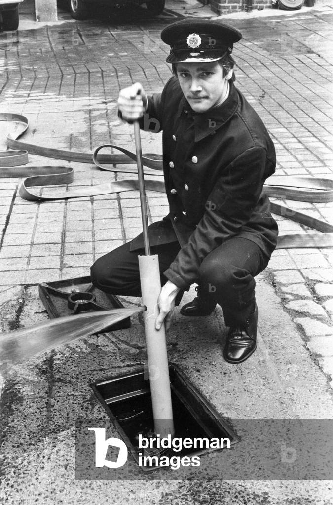 Fireman Kevin Lee tries the new pump for cleaning silt and sludge from fire hydrants, that was invented by one of his colleagues, 1970