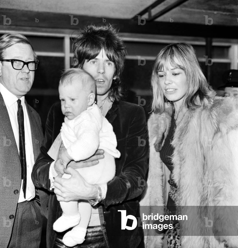 Rolling Stones, Keith Richard at Heathrow Airport with Anita Pallenberg and their 4 months old baby Marlon. 8th December 1969, two days after the band's infamous appearance at the Altamont Festival in San Francisco