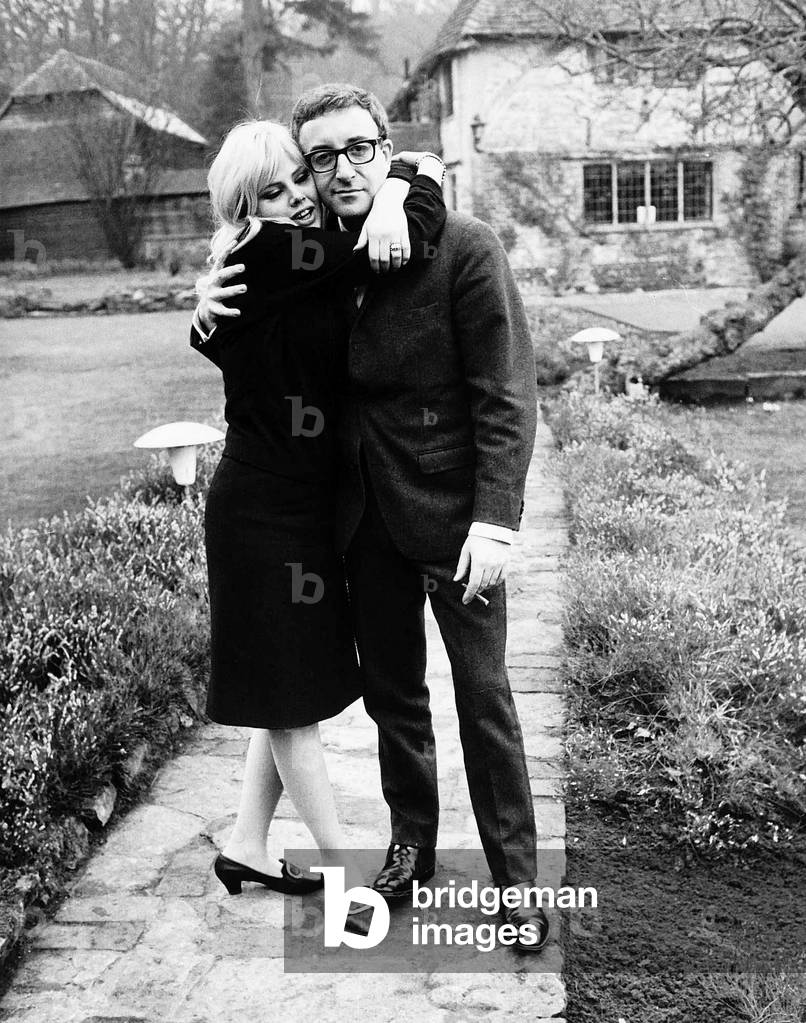 Peter Sellers actor with actress Britt Ekland at home in their garden, 13th February 1964 (b/w photo)
