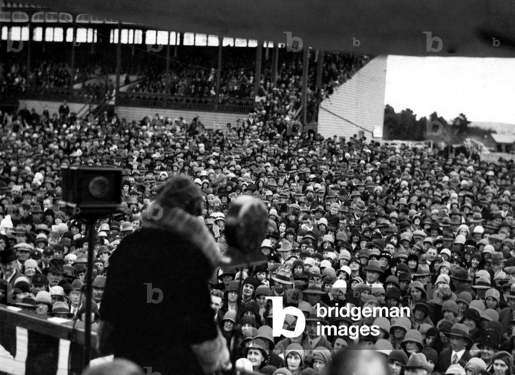 Miss Amy Johnson acknowledging the enthusiastic welcome given to her at the Geelong racecourse in Victoria, Australia after her attempted record breaking solo flight from London to Darwin 
June 1930
