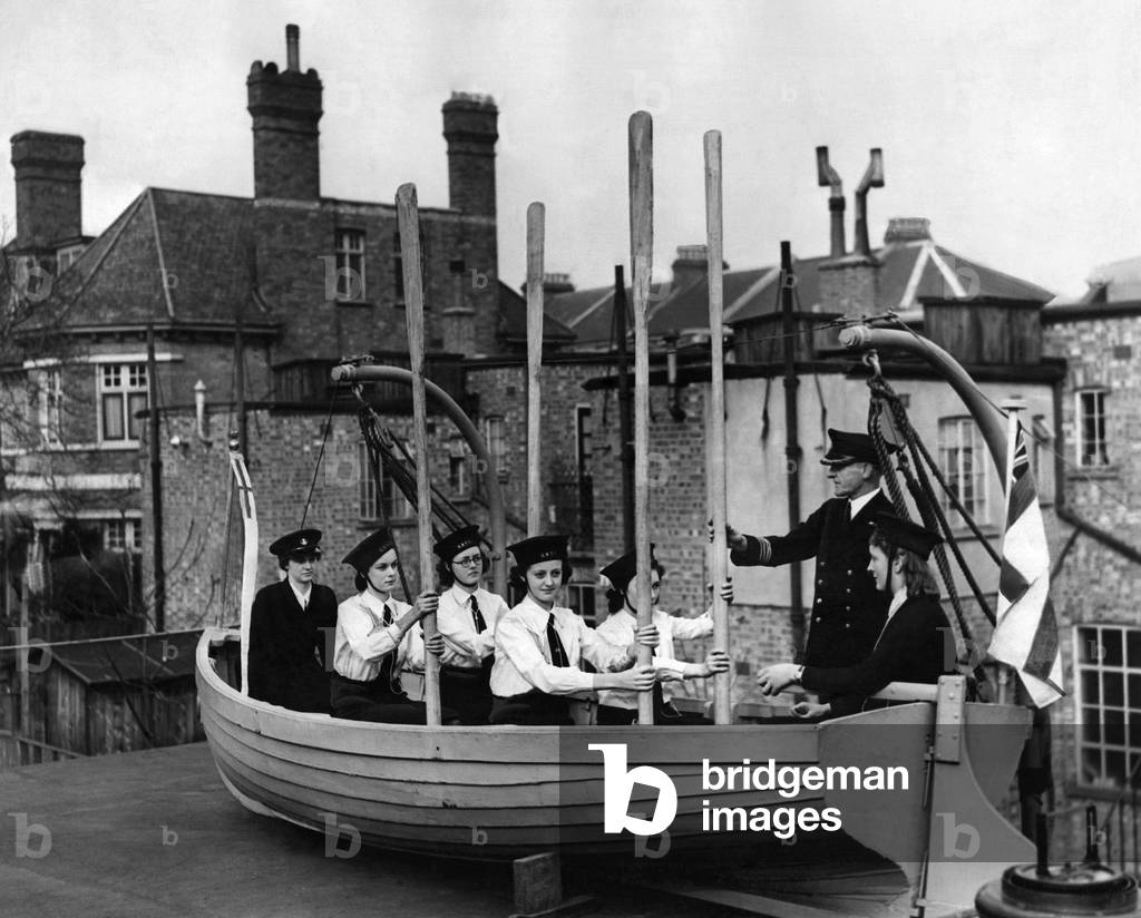 Naval training corp girls learning how to row a boat during the war. 
March 1943