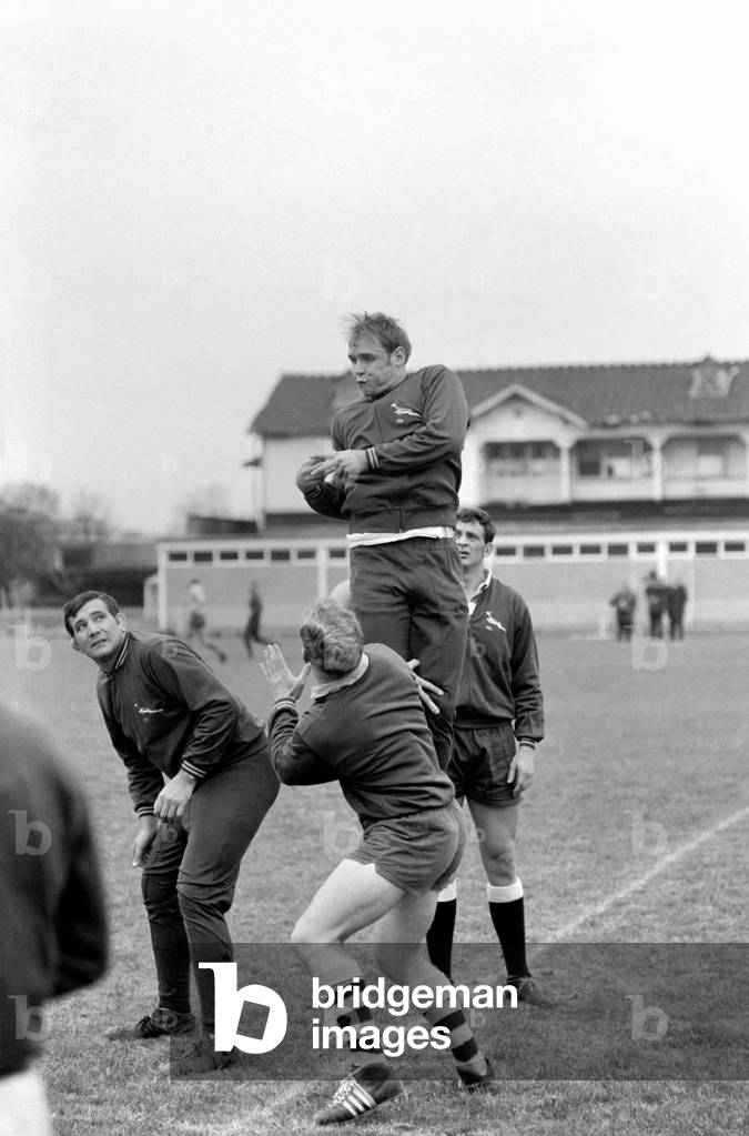 Sport: The South African springbok rugby team that flew in yesterday to be welcomed by anti-apartheid demonstrators at London Airport were shouted at and had banners waved in their faces during their practice session at the Richmond Athletic Association ground. 
The demonstrators were escorted from the ground by the police. 
The springbok players pictured during training this morning. 
October 1969