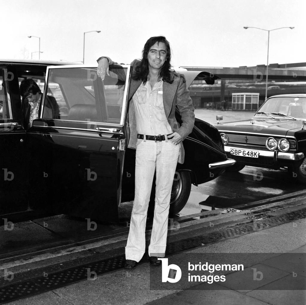 American rock singer Alice Cooper arrives in London ahead of his tour, 15th March 1974 (b/w photo)
