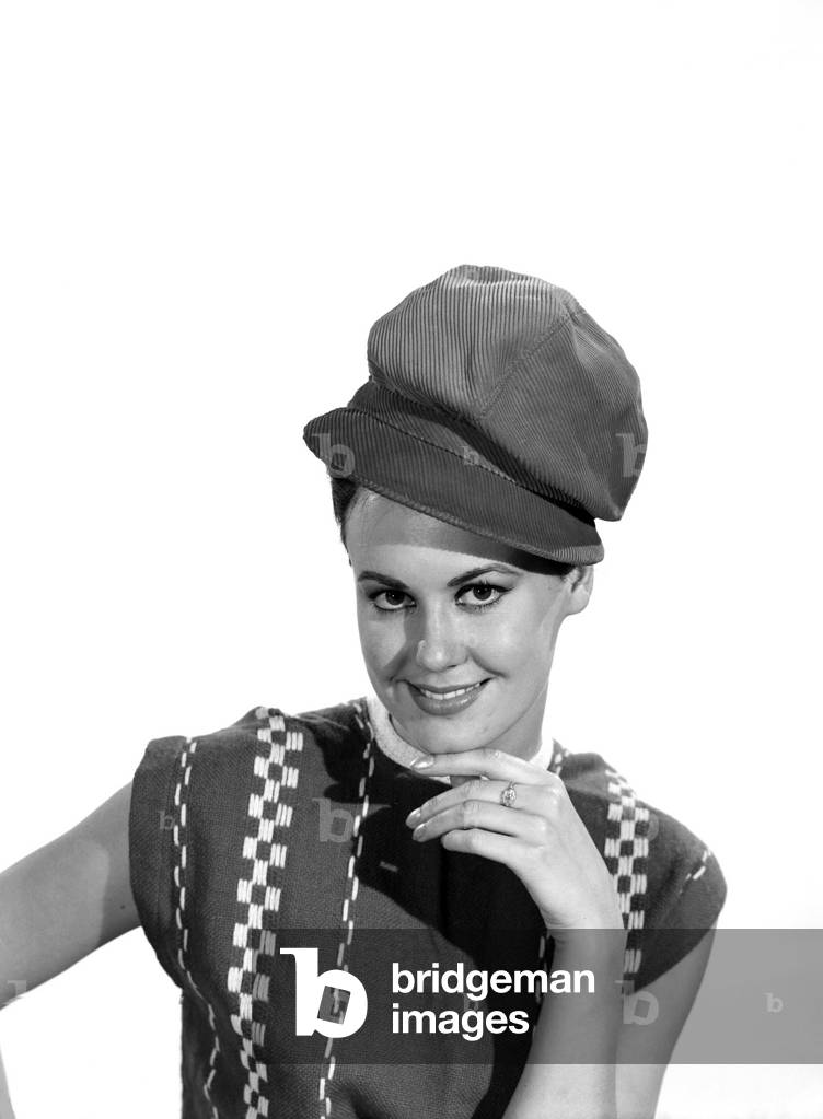 Model Jackie White wearing red coduroy hat, c. 1963 (b/w photo)