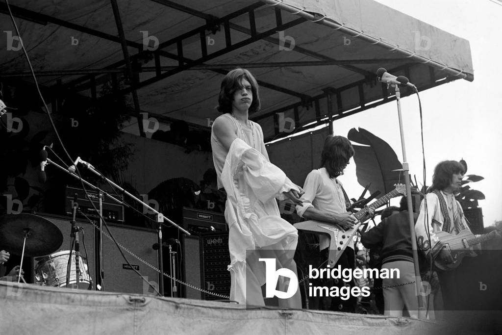 The Rolling Stones on stage at their free concert in London's Hyde Park on 5 July 1969. Mich Jagger taking off the Mr Fish 'dress'