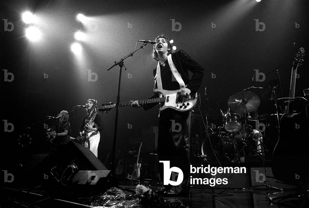 Paul McCartney, formerly of The Beatles, singing with Denny Laine of their new group Wings in concert in USA, May 1976 (b/w photo)