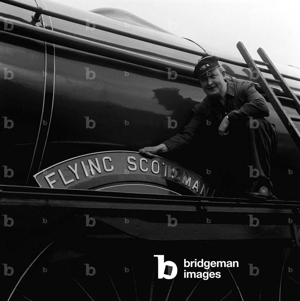 Horrified that Flying Scotsman was not on any official preservation list businessman Alan Pegler, seen polishing the celebrated nameplate, bought the great locomotive for £3,000, less than half its £7,944 construction cost 40 years earlier, January 1963 (b/w photo)
