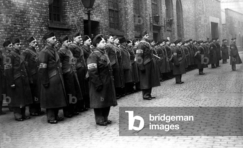 Post Office members of the Home Guard on Sunday morning parade at the Orchard Street sorting office, Newcastle.
 February 1941