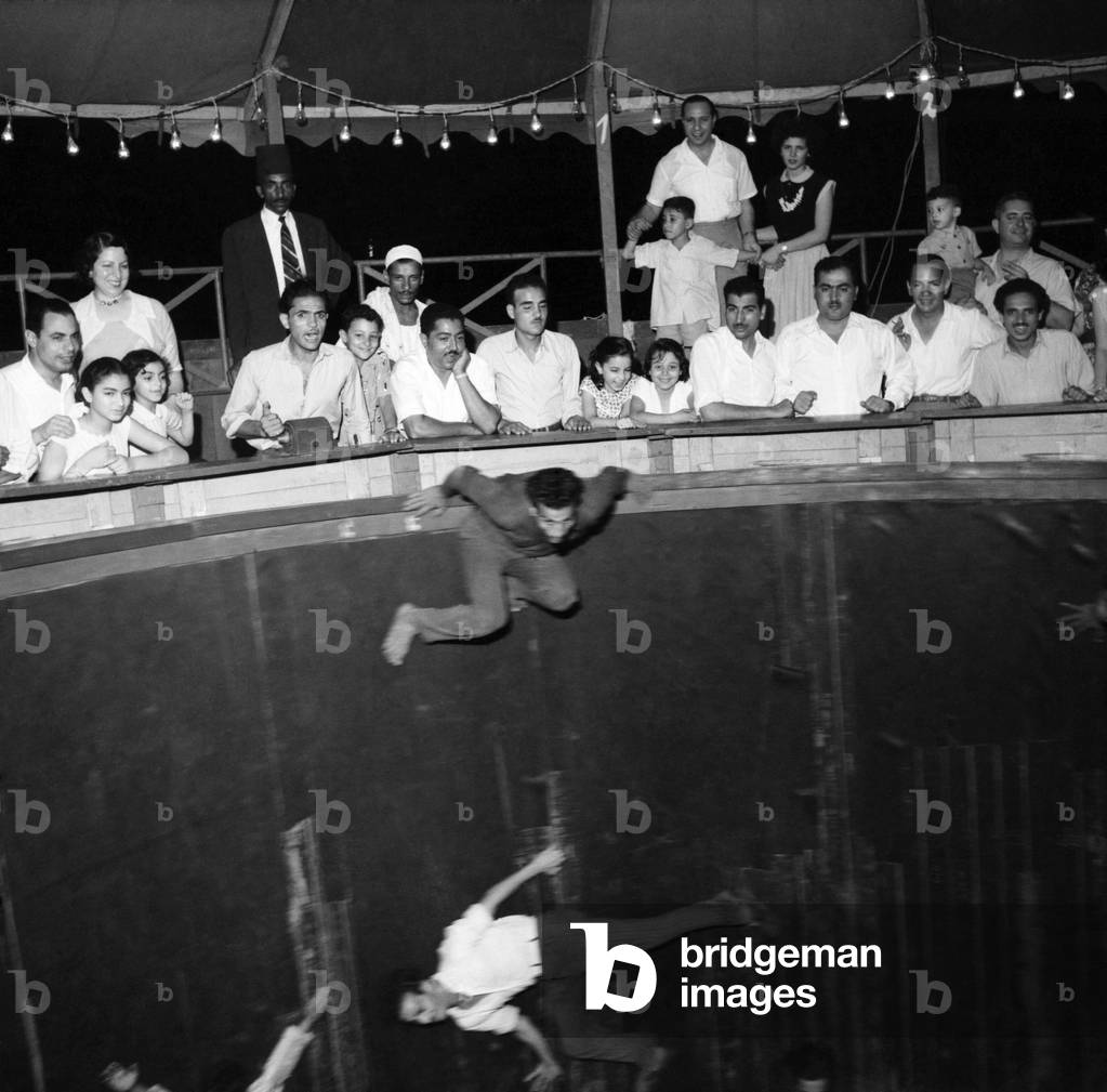 Egypt: Cairo funfair Egyptian families enjoying a night of fun at the fair on the outskirts of the city. The rotor ride was particular favourite. July 1953