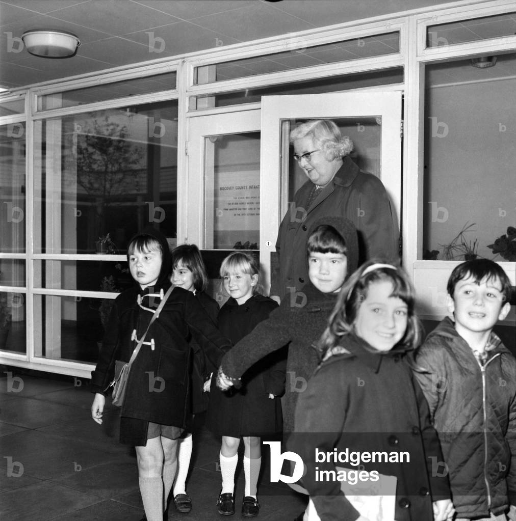 Education School: Miss Marjorie Wilson, sister of the Prime Minister, did not join in the Teachers Strike but attended her school at Biscoveey, Cornwall. In the absence of staff teachers, headmistress Miss Wilson shepherds the children out of school and into the school bus. November 1969