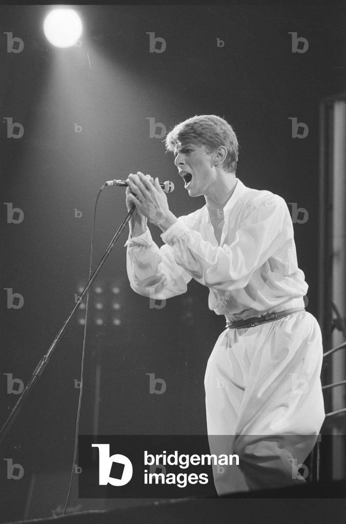 British pop singer David Bowie performing on stage during concert at Wembley, 29th June 1978 (b/w photo)