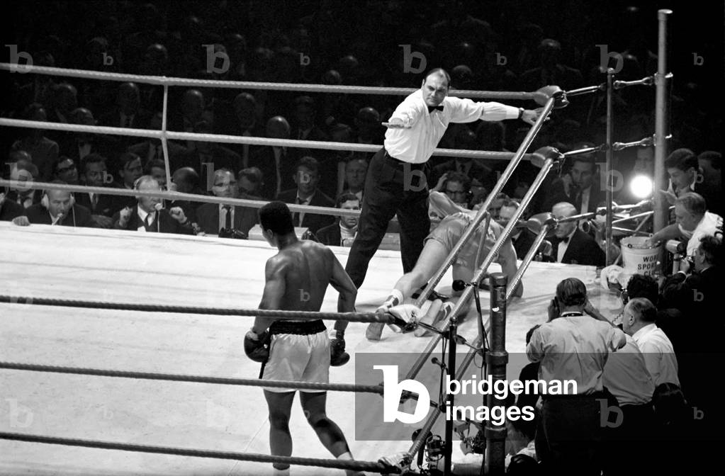 Heavy weight championship of the world between Cassius Clay v. Brian London at Earls Court: Referee Harry Gibbs counts out Brian London, August 1966 (b/w photo)