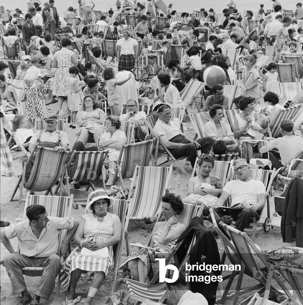 A busy scene on the seafront at Margate, Kent with holidaymakers packing the beach during the Summer holidays. 3rd August 1961 (b/w photo)