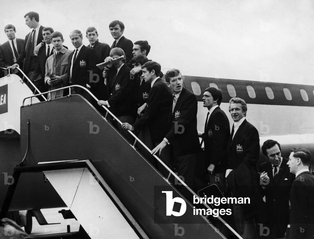 Manchester United seen here boarding a plane at Manchester Ringway airport for their European Cup match semi final match against Real Madrid 14th May 1968 (photo)