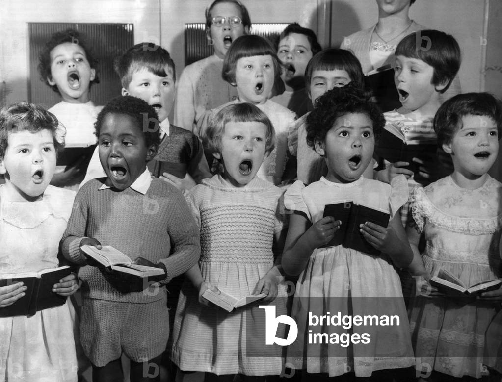 A choir of children sing at the Dr Barnado's Farm Hill in Kelvedon Essex, Christmas, 1963 (b/w photo)
