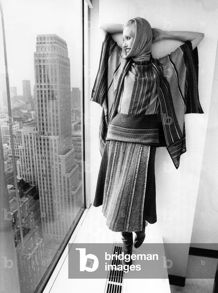 Model wearing a clutch cargo-striped wool, Mohair and silk skirt, May 1977 (b/w photo)