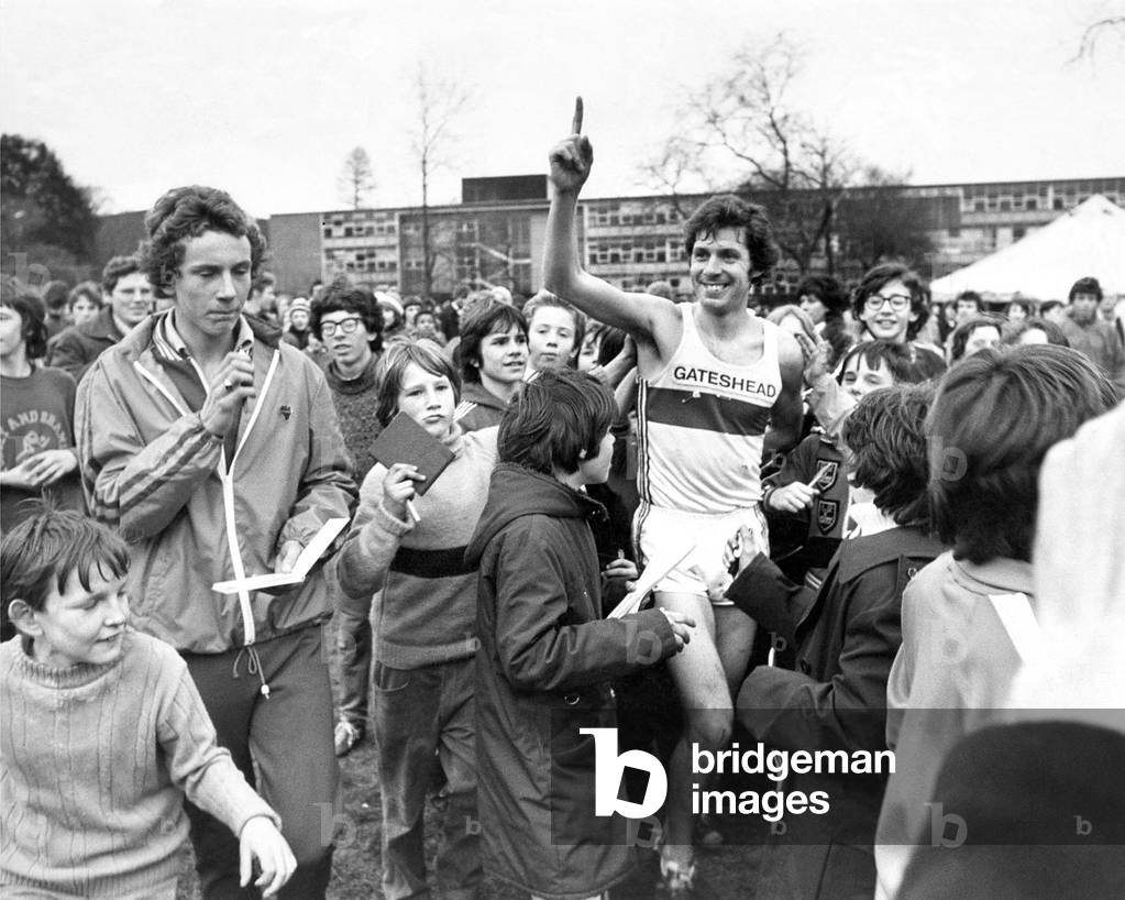 Brendan Foster (Gateshead Harriers) receives congratulations on his win from excited young fans at Parliament Hill Fields, London, 05/03/1977 (b/w photo)