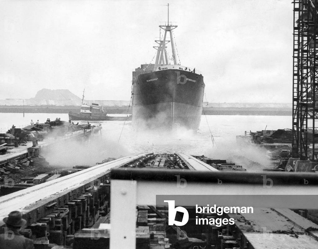 Launching of the cargo ship Rembrandt , built and engine by the Smith's Dock Company Ltd for the Bolton Steam Shipping Company Ltd, at Smiths Dock at South Bank on the River Tees. 29th January 1960 (b/w photo)