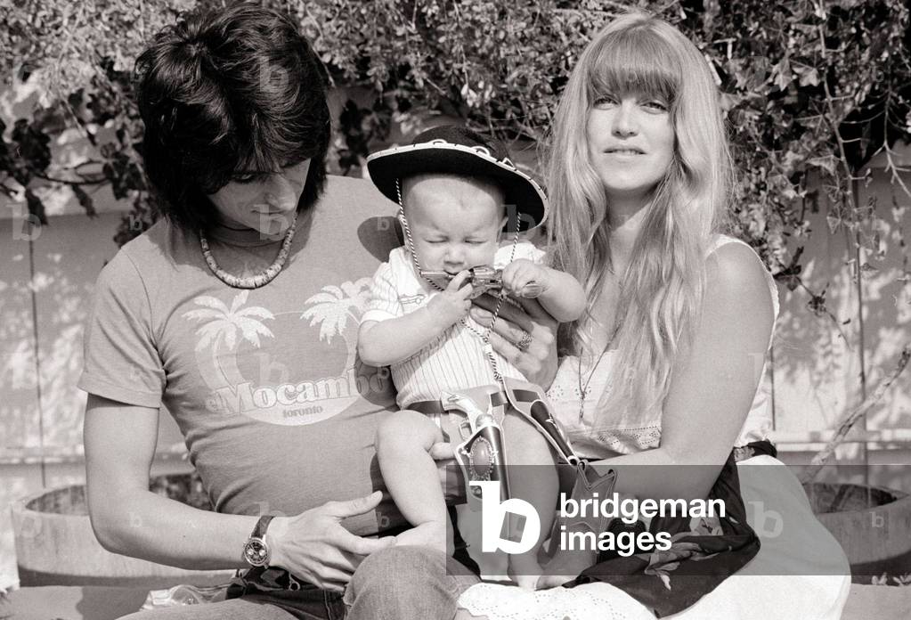 Ronnie Wood of the Rolling Stones - April 1977
with his wife Krissie Wood and baby Jesse James Wood at their Malibu beach home in Califonia, USA.