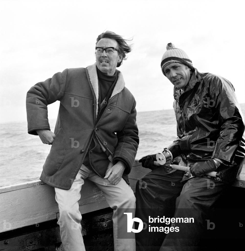 Sport: Angling: Hal Mount (glasses) with Police Constable Derek Rogers fishing off the Isle of Wight. November 1969