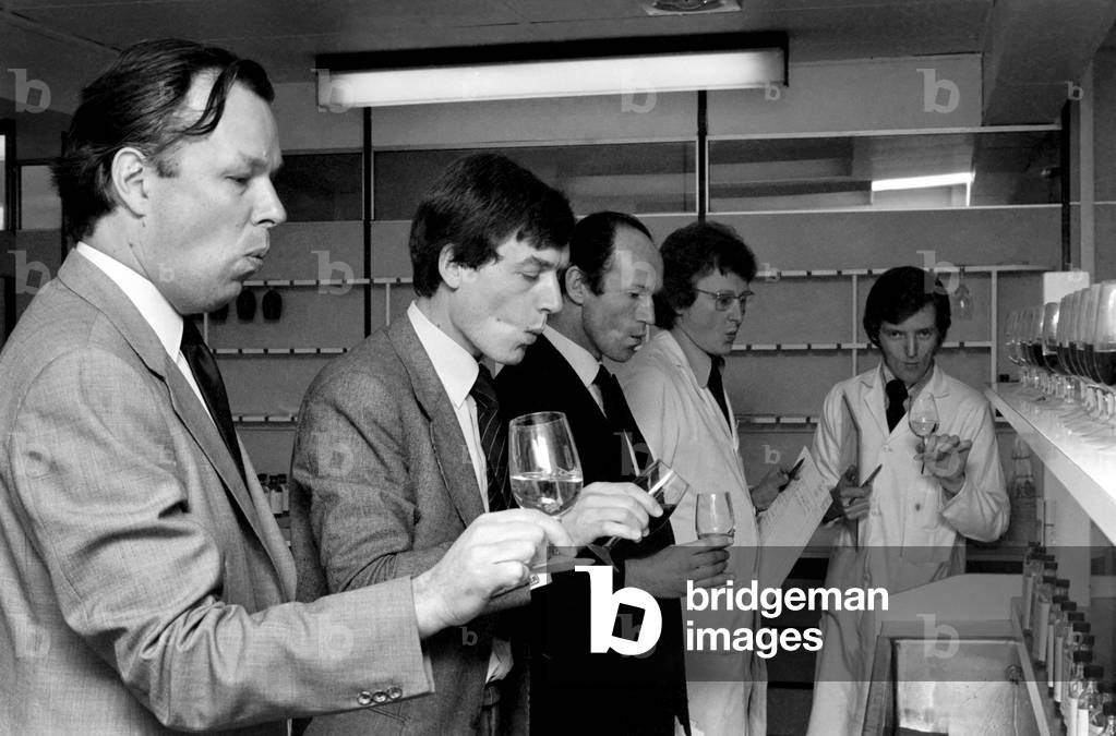 Wine Taster sampling the latest consignment of red wine from the Beaujolais region of France, April 1977 (b/w photo)