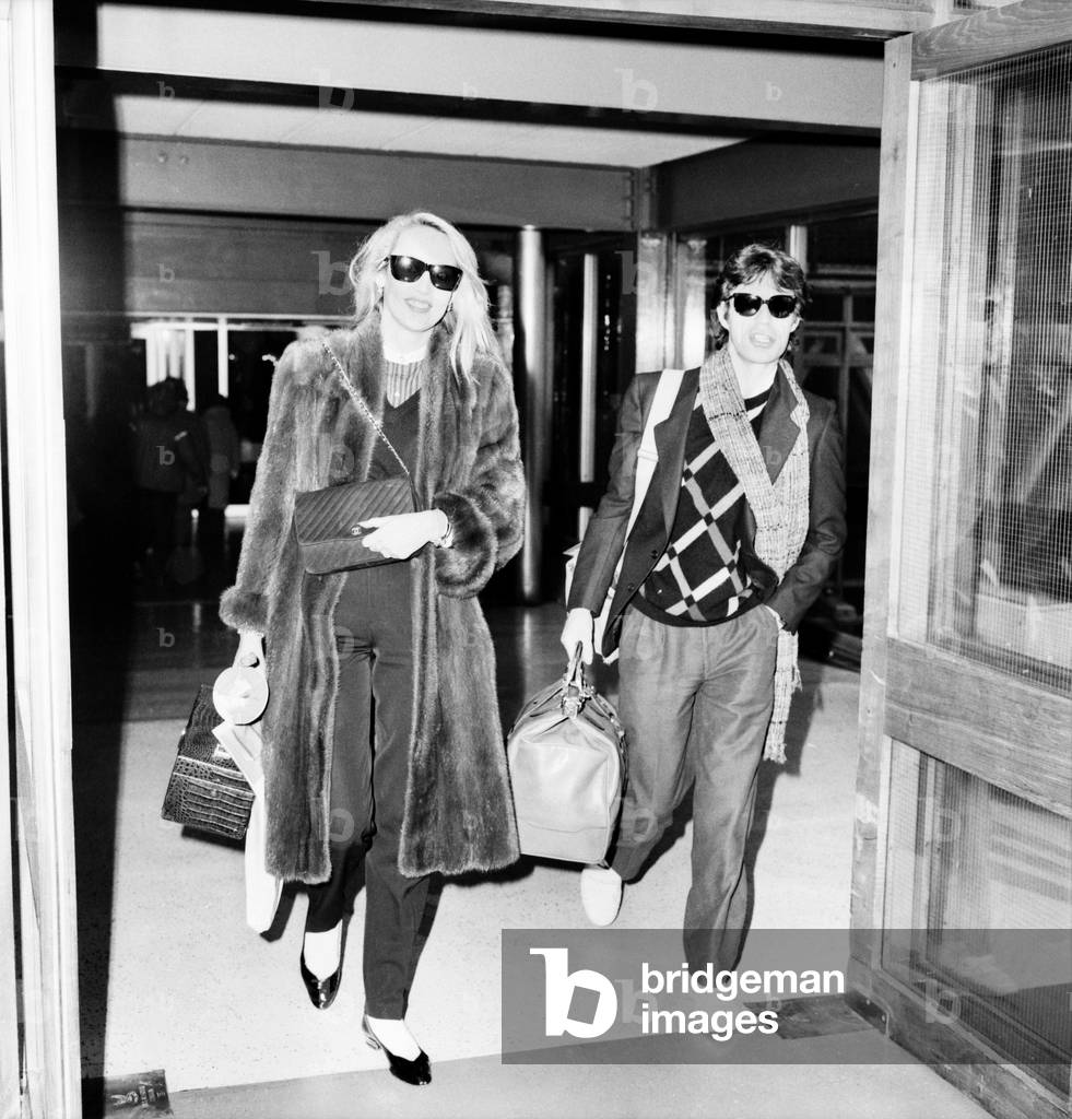 Rolling Stones. Mick Jagger and Jerry Hall leaving London Airport Heathrow for a Christmas Holiday in Barbados. 19 December 1982