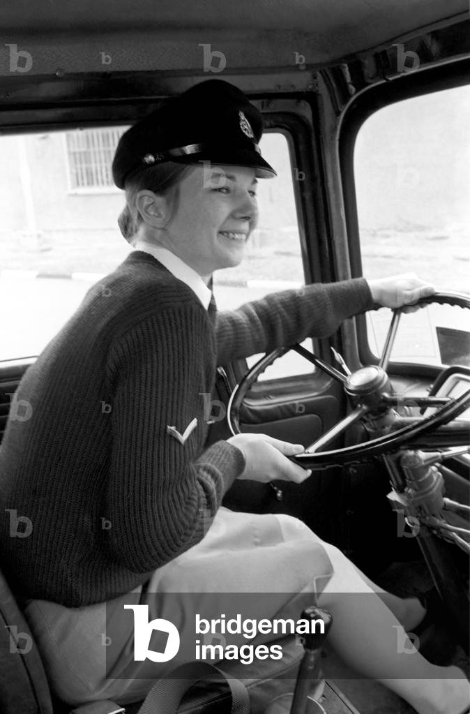 An Army girl in Germany learns to handle an army lorry instead of the usual Staff cars, April 1975 (b/w photo)