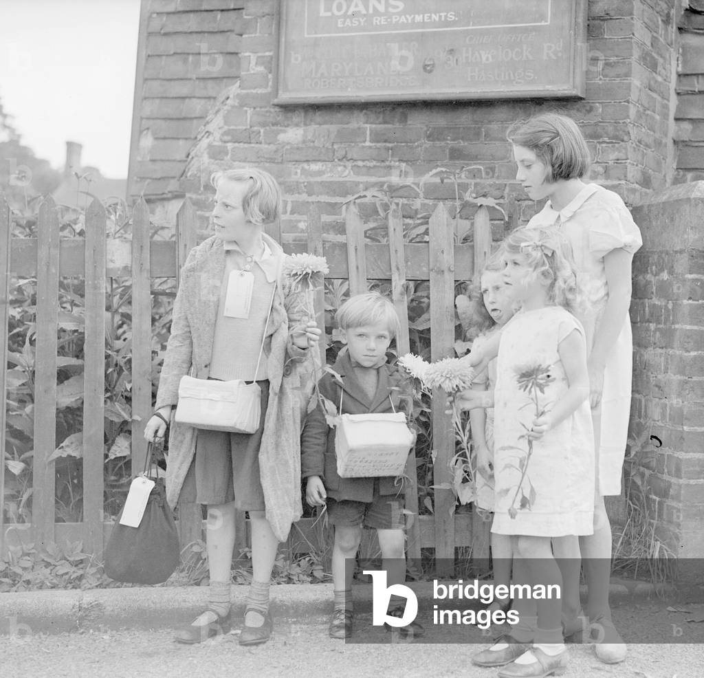 Local children greeting the evacuees with flowers, 3rd September 1939 (b/w photo)