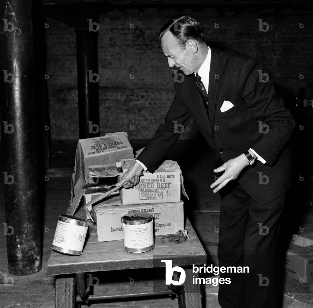 Typhoid outbreak. Aberdeen. Scotland. 1964. In 1964 there was an outbreak of typhoid in the city of Aberdeen, Scotland. The first two cases were identified on 20 May 1964; eventually over 400 cases were diagnosed and the patients were quarantined at the City Hospital in Urquhart Road, but no fatalities resulted. The outbreak was eventually traced to contaminated tinned corned beef from South America made by Fray Bentos and sold in the city's branch of the Scottish grocery chain William Low. The infected meat then contaminated a meat slicing machine within the William Low shop, leading to the spread of the disease. Pictured. Discarded Tins of corned beef from Argentina, 31st May 1964 (b/w photo)