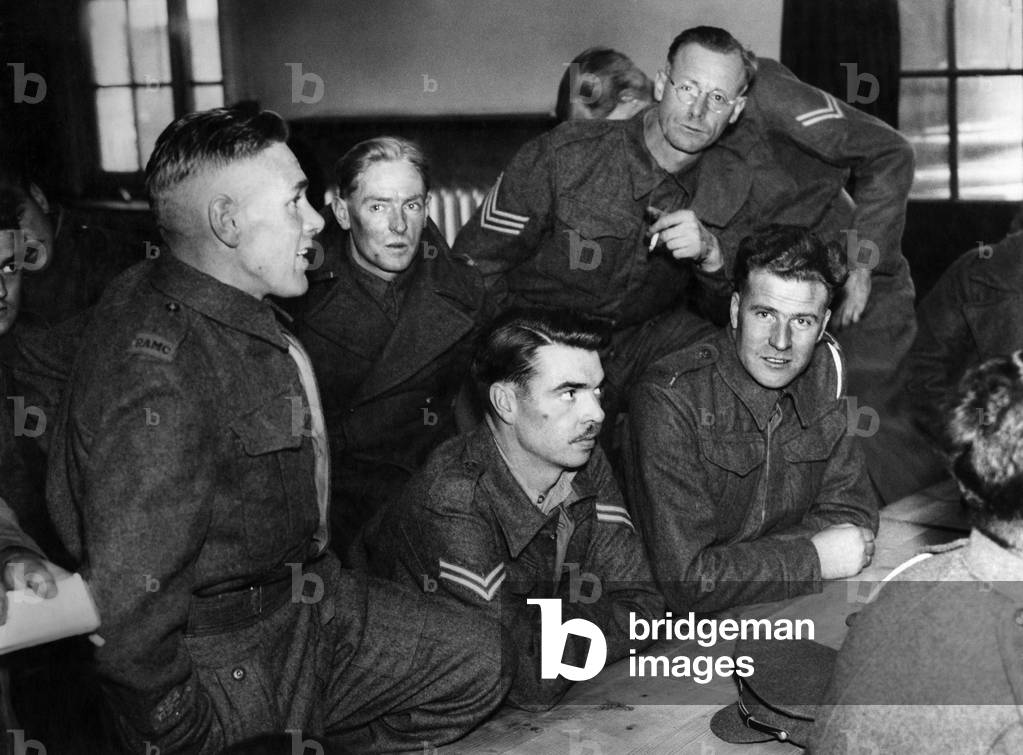 R.S.M. T.H. Bennett of Portsmouth (left of pic) with some of the 16 repatriated prisoners - swapping experiences of life in Italian prison camps. June 1942