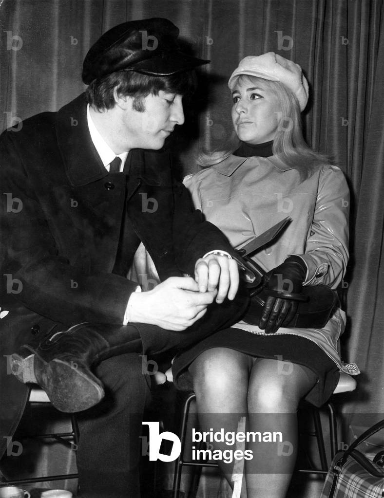 The Beatles - John Lennon pictured with his wife Cynthia in the lounge of London airport - before the group boarded their plane for a trip to America for an appearance on the Ed Sullivan TV Show - 7th February 1964